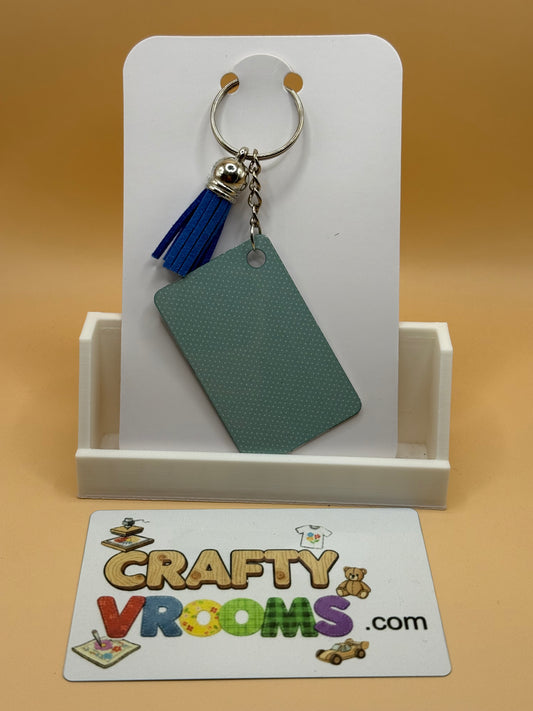 Rectangle keychain w/tassel - Academia Crow
